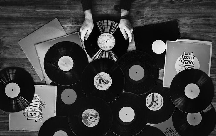 multiple vinyl records spread across a table